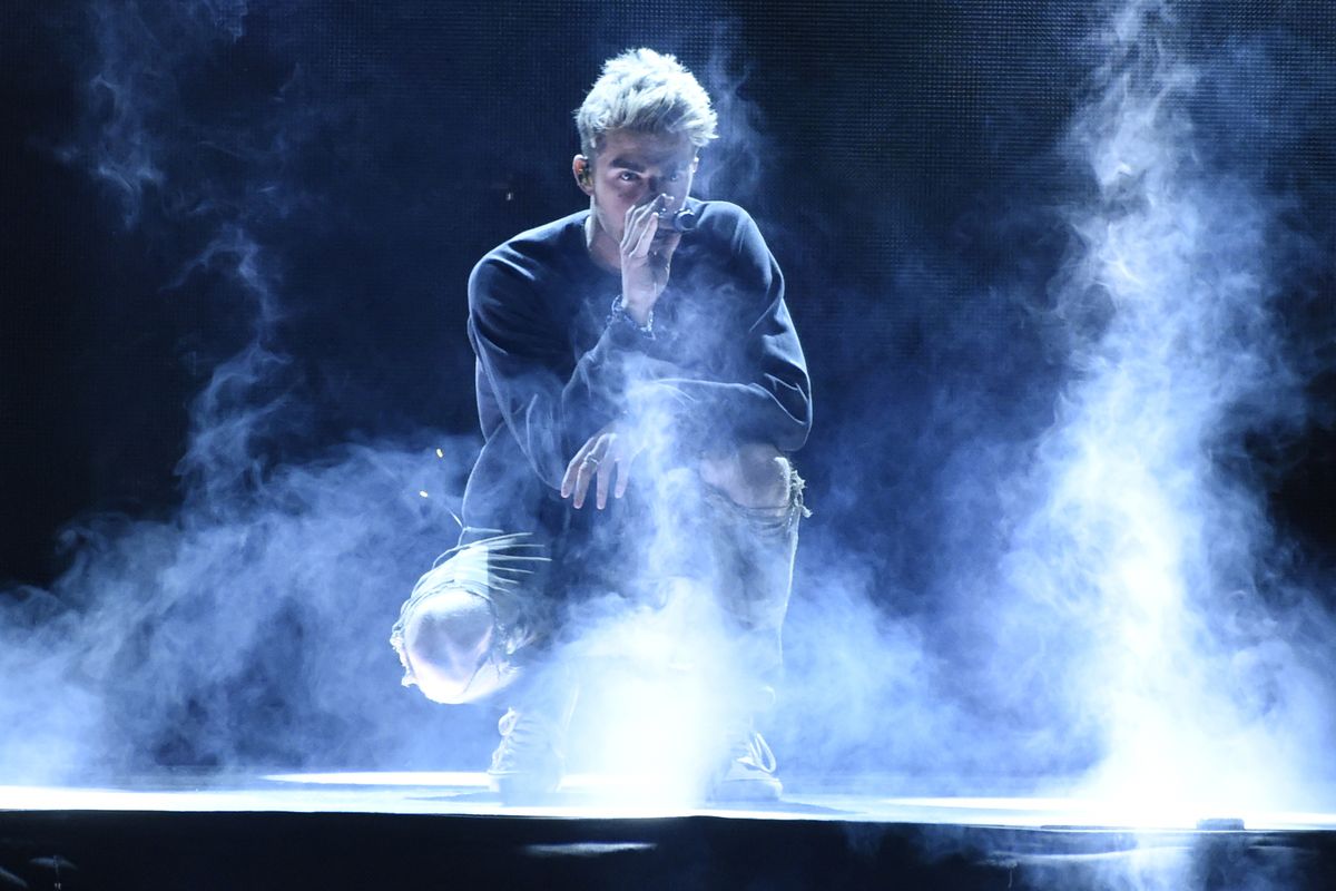 FILE - In this April 19, 2018 file photo, Andrew Taggart, of The Chainsmokers, performs "Sick Boy" at WE Day California at The Forum in Inglewood, Calif. New York