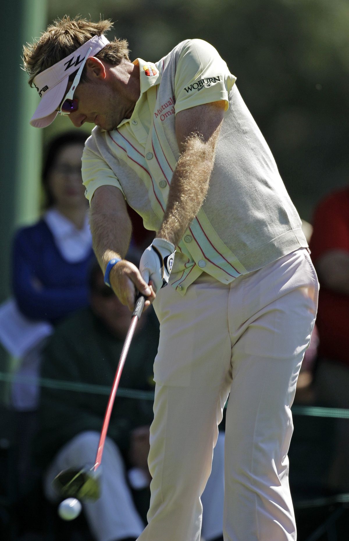 Ian Poulter tees off on the 18th hole, finishing in a tie for first after the second round.  (Associated Press)