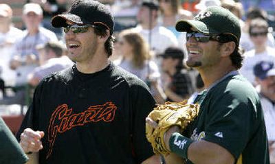 
Former Oakland pitcher Barry Zito, now with San Francisco, visited with ex-teammate Eric Chavez, right, during a spring game. 
 (Associated Press / The Spokesman-Review)