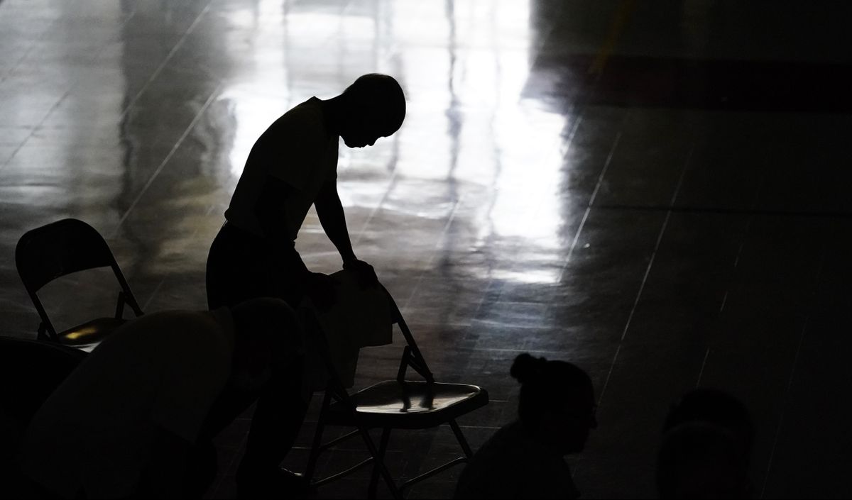 A man prays during Mass in the gymnasium at St. Joan of Arc Catholic Church in LaPlace, La., Sunday, Sept. 5, 2021, in the aftermath of Hurricane Ida. ​  (Matt Slocum)