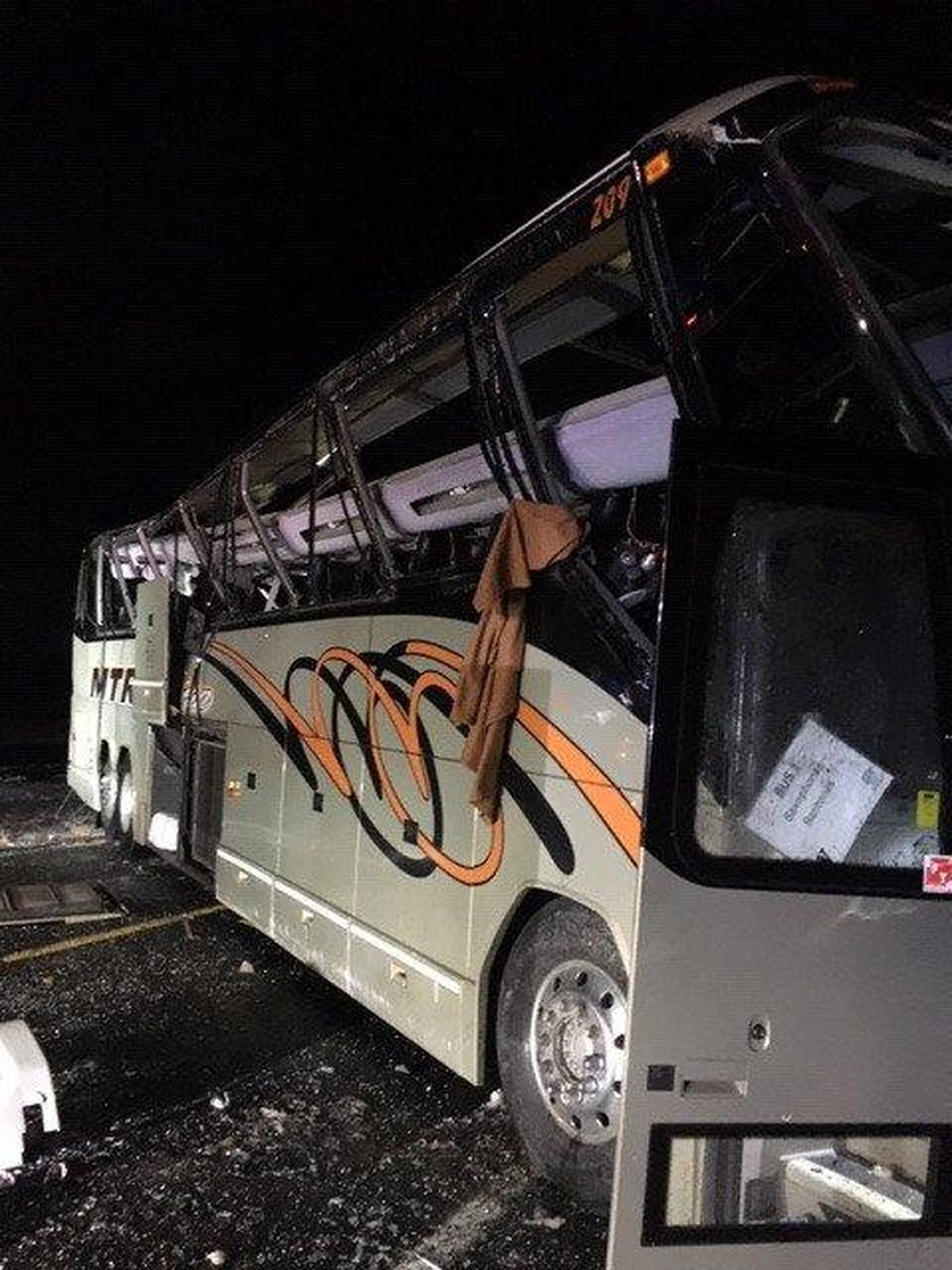 A charter bus carrying members of the University of Washington marching band rolled onto its side Thursday evening on an icy stretch of Interstate 90 near George, Washington. The band subsequently canceled its trip to Pullman, where it was scheduled to perform Friday night during the Apple Cup rivalry game against Washington State University. (Washington State Patrol)