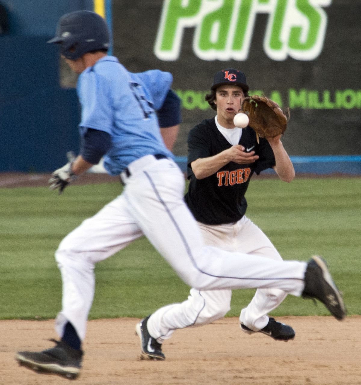 Lewis and Clark third baseman Patrick Smith gobbles up a ground all as Gonzaga Prep’s Kevin Thomas heads toward third base in the fourth inning on Monday’s 12-inning, 3-1 Tigers win at Avista Stadium. (Dan Pelle)