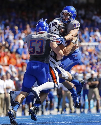 Tennessee-Martin QB Dylan Favre is tackled by Boise State DL Beau Martin, left, and LB Darren Lee. (Associated Press)