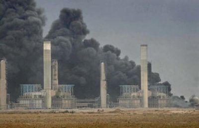 
An oil refinery is seen in front of billowing black smoke from an oil pipeline fire Thursday in the northern city of Kirkuk. 
 (Associated Press / The Spokesman-Review)