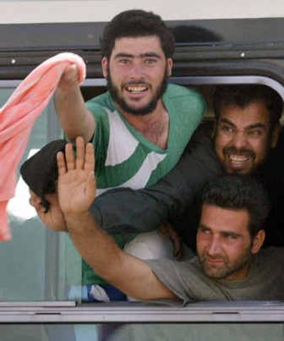 
Detainees wave after being released from Abu Ghraib prison, outside Baghdad. More than 400 prisoners were freed.Detainees wave after being released from Abu Ghraib prison, outside Baghdad. More than 400 prisoners were freed.
 (Associated PressAssociated Press / The Spokesman-Review)