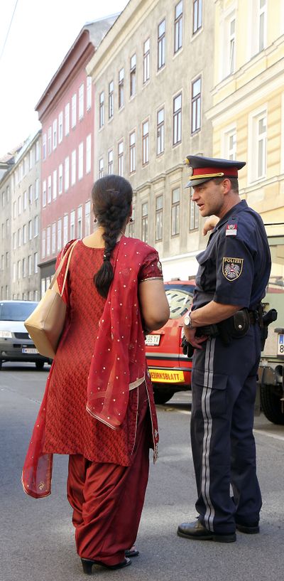 A woman talks to a policeman Sunday  near the Vienna temple.  (Associated Press / The Spokesman-Review)