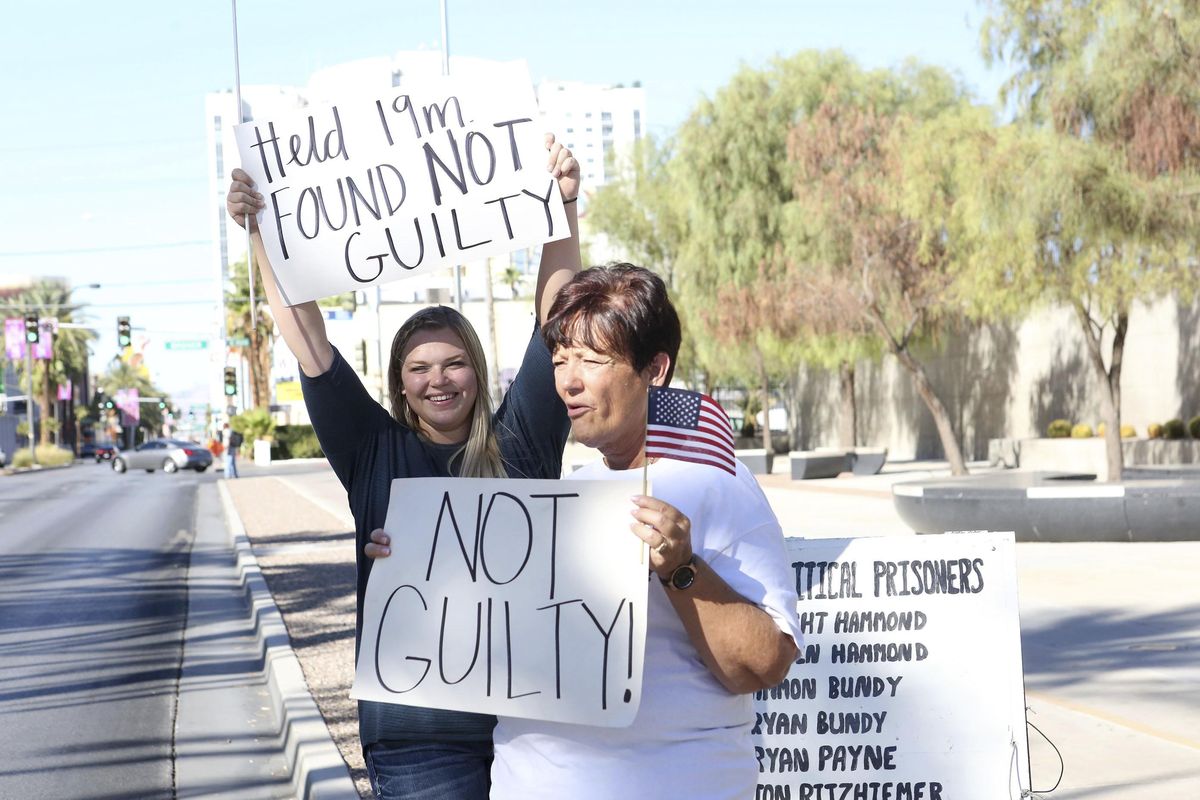 Cliven Bundy’s daughter, Bailey Bundy Logue, left, and Margaret Houston of Logandale, Nev., wave signs in front of the Lloyd George U.S. Courthouse in Las Vegas after the not guilty verdict in the Bunkerville, Nev., standoff retrial Tuesday, Aug. 22, 2017. (Michael Quine / Las Vegas Review-Journal)