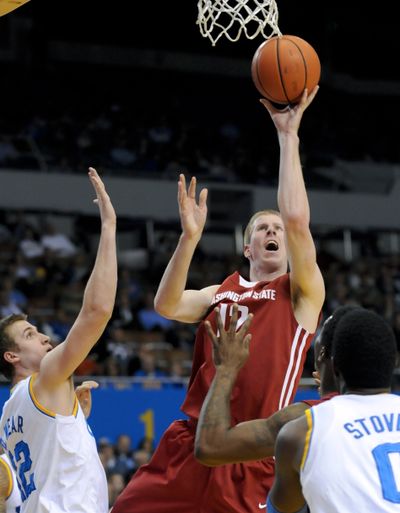 WSU forward Brock Motum, center, scored over a quarter of the Cougars’ points this season. (Associated Press)