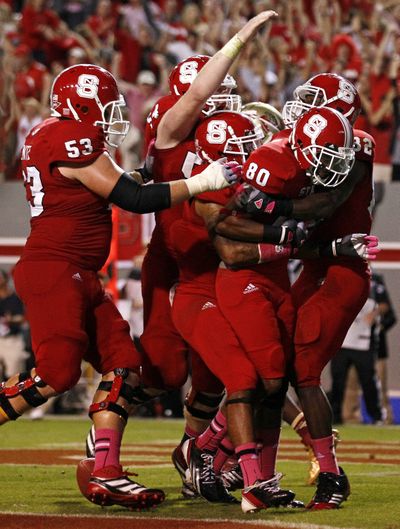 North Carolina State’s Bryan Underwood (80) is congratulated by teammates after his touchdown catch to tie the game with 16 seconds left to play in a victory over No. 3 Florida State. (Associated Press)