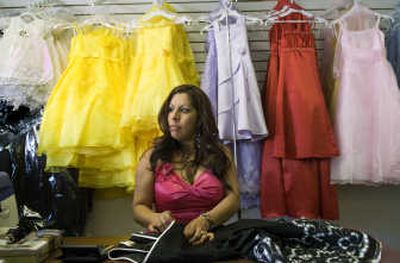 
Herlinda Zambrano, 36, alters a dress in her shop in downtown Pasco on Saturday. A native of Michoacan, Mexico, she is part of a growing immigrant population that has made Franklin County the first county in Washington state to be majority Latino. 
 (Colin Mulvany / The Spokesman-Review)