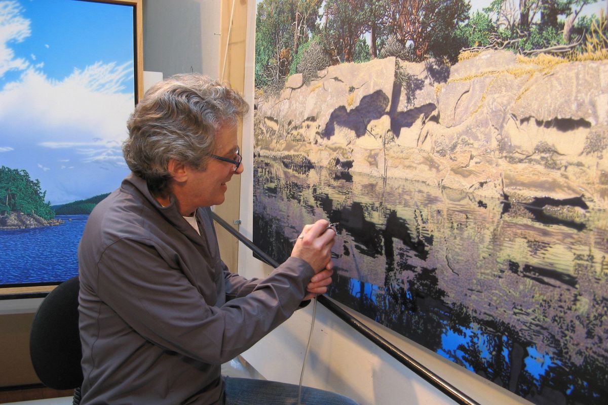 Artist Jim McKenzie works with an airbrush in his studio on Mayne Island in British Columbia. Seattle Times (Seattle Times)