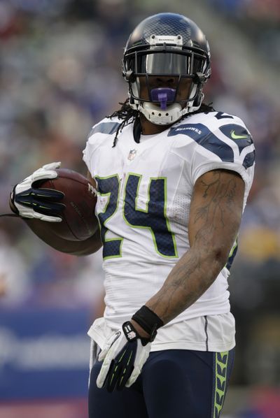 Seattle and Marshawn Lynch got 11 of 12 first-place votes. (Associated Press)