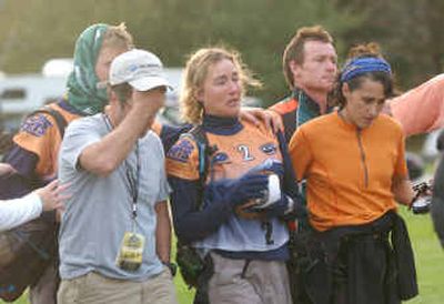 
Subaru Primal Quest adventure race competitors are escorted away from a helicopter by staff after being airlifted from the scene of an accident in rugged terrain close to Illabot Peak near Rockport, Wash., on Tuesday. A falling boulder struck and killed an Australian man during an intense 400-mile race through northwest Washington. 
 (Associated Press / The Spokesman-Review)