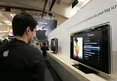 
A MacWorld Conference & Expo attendee checks out the Apple TV in San Francisco during last year's  Macworld Conference. Apple's stock has doubled since the 2007 event. Associated Press
 (File Associated Press / The Spokesman-Review)