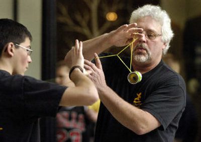 
John Bozung, 55, warms up with Jared Villarreal, 15, before the Inland Empire Yo-Yo Challenge on Saturday at River Park Square. Bozung won the World Overall Sport Division in Orlando, Fla., in 2002 and the National Overall Sport Division in Chico, Calif., in 2003. Both competitors are from the Tri-Cities. 
 (Dan Pelle / The Spokesman-Review)