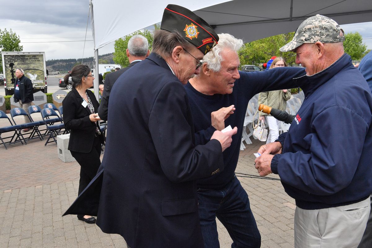 Bobby Brett, center, majority owner of the Spokane Indians chats Thursday at Avista Stadium with Vietnam veterans Tim Welsh, with Garco Construction, right, and Wes Anderson, with the VFW, left, after an event announcing the Indians entering a partnership with Team Fairchild, STCU and Innovia to debut Operation Fly Together Center, which honors and supports local military veterans.  (TYLER TJOMSLAND/THE SPOKESMAN-REVIEW)