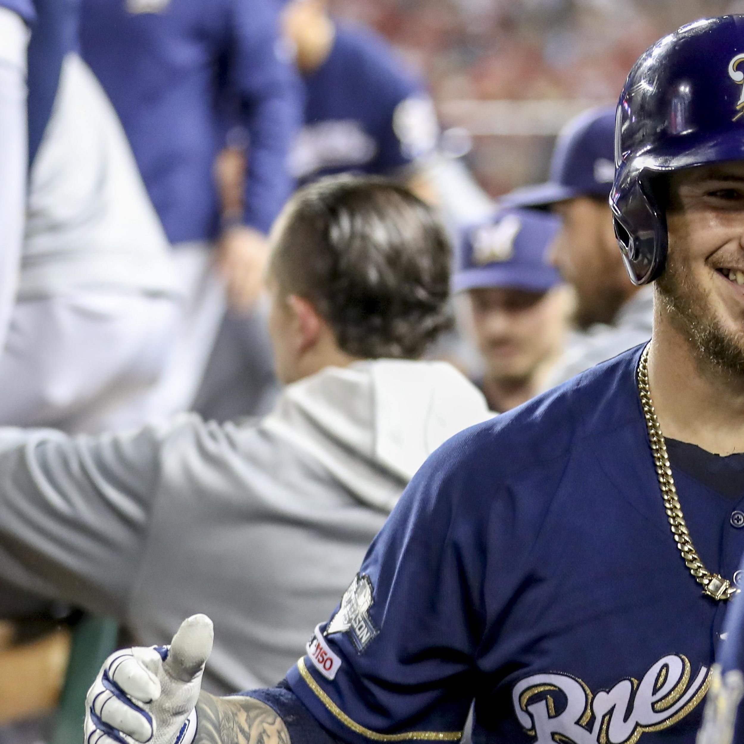 Milwaukee Brewers' Yasmani Grandal, center, celebrates with