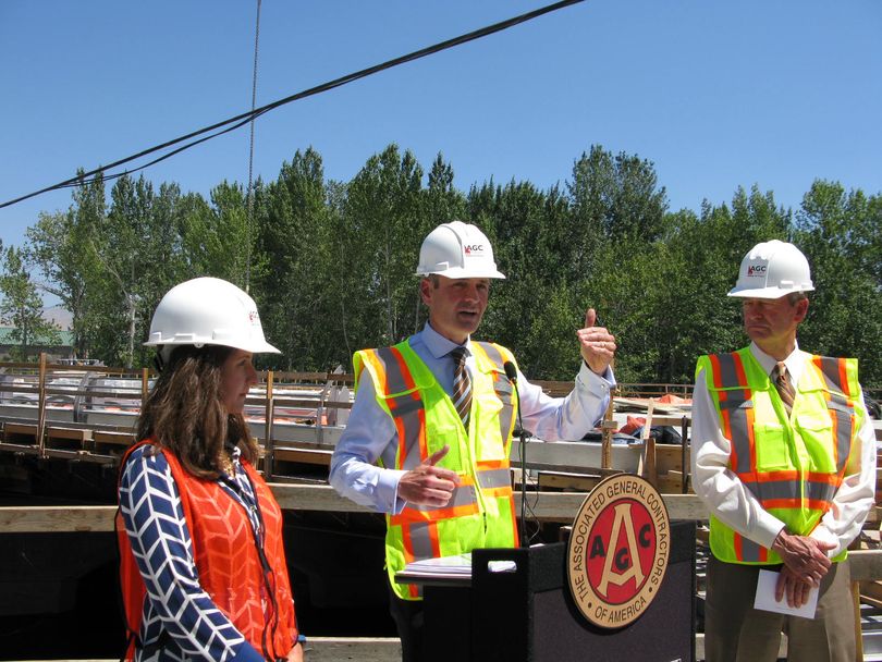 Brian Turmail, national spokesman for the Associated General Contractors of America, speaks at the Broadway Bridge construction site in Boise today; at left is state Commerce Director Megan Ronk, and at right is Lt. Gov. Brad Little. (Betsy Z. Russell)