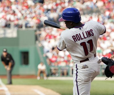 Phillies’ Jimmy Rollins follows through on his grand slam in the sixth inning of Saturday’s game.  (Associated Press / The Spokesman-Review)