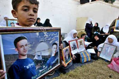
Relatives of Palestinian prisoners jailed in Israel demand their release at the Red Cross office in Gaza City on Monday. Israel said it approves of the release of 170 Palestinian prisoners, officially as a gesture to Egypt, but also as encouragement to interim Palestinian leader Mahmoud Abbas. 
 (Associated Press / The Spokesman-Review)