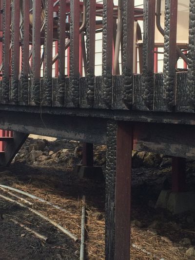 The Fish Lake Fire got close enough to the home of Elaine and Davy Caven on Scribner Road that it charred their deck. A crew of three Spokane County Fire District 3 firefighters, cut off from assistance, were able to keep the flames at bay.  (Nina Culver)