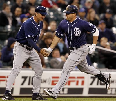 San Diego Padres' Yonder Alonso, right, is congratulated after his home run by third-base coach Glenn Hoffman. (Associated Press)