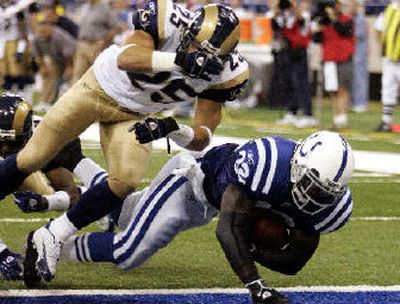 
Colts running back Edgerrin James scores under St. Louis' Mike Furrey. 
 (Associated Press / The Spokesman-Review)