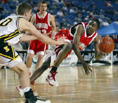 
 Josh Rhodes of Ferris, right, makes a diving pass in the first quarter with Matt Conroy providing the defense for Inglemoor, an eventual 63-52 winner. 
 (John Froschauer/Special to / The Spokesman-Review)