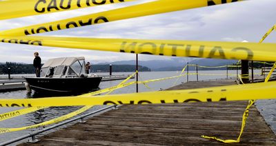 Part of the boat docks at Honeysuckle Beach are yellow taped off for safety as Linda Ely of Kootenai County Noxious Weed Control docks the boat after a morning of water testing at Hayden Lake. Kootenai County has received a $61,000 grant from the Idaho Department of Parks and Recreation, and part of that money will be used   for new docks at Honeysuckle Beach.  (Kathy Plonka / The Spokesman-Review)