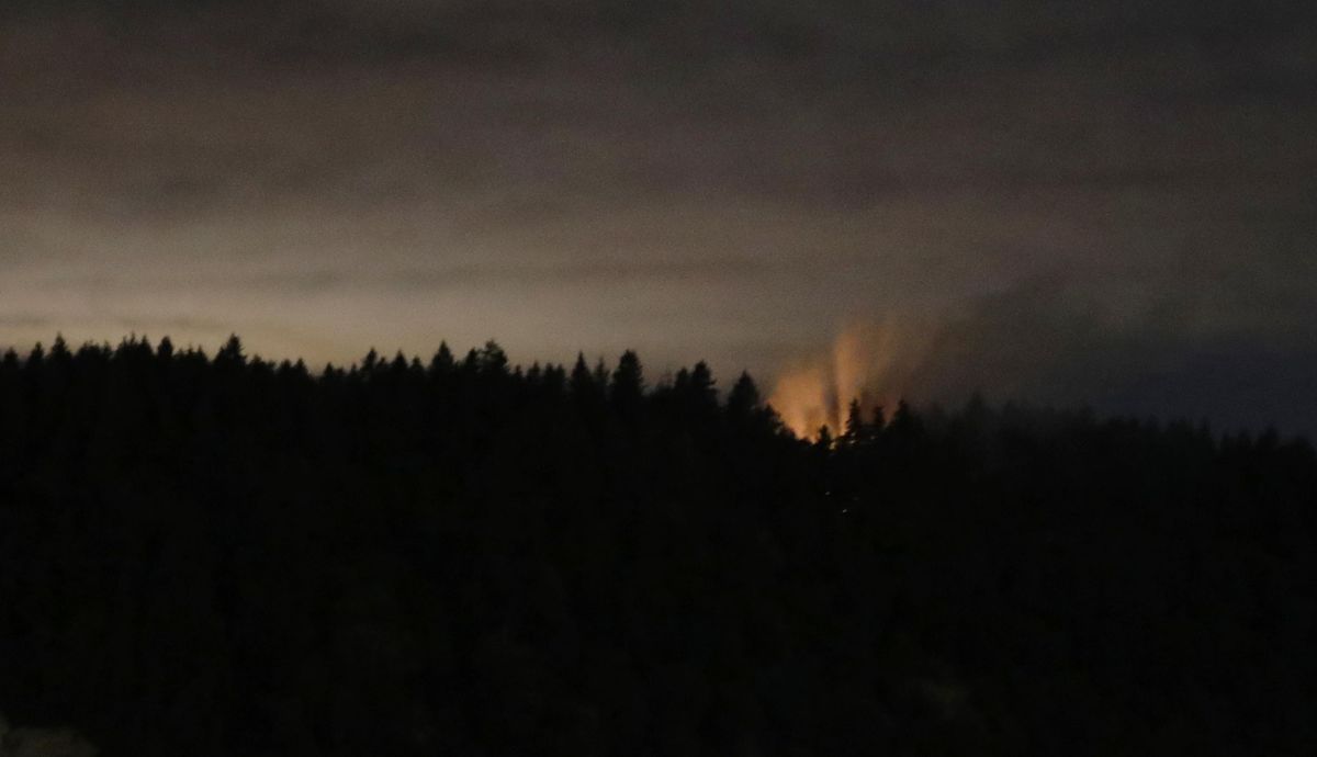 In this long-exposure photo, smoke and an orange glow are seen on Ketron Island in Washington state, early Saturday, Aug. 11, 2018 as viewed from near Steilacoom, Wash. On Friday, an airline mechanic stole an empty Horizon Air turboprop plane, took off from Seattle-Tacoma International Airport and was chased by military jets before crashing onto Ketron, a small island in the Puget Sound, on Friday night, officials said. (Ted S. Warren / Associated Press)