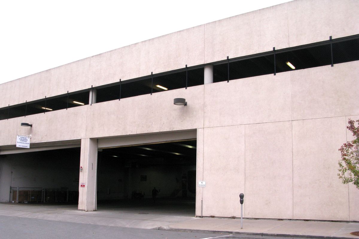 Present day: The Spokesman-Review Production Facility, with shipping doors at street level and parking above, sits on the site of the first Pigeon Hole Parking lot. (Jesse Tinsley)