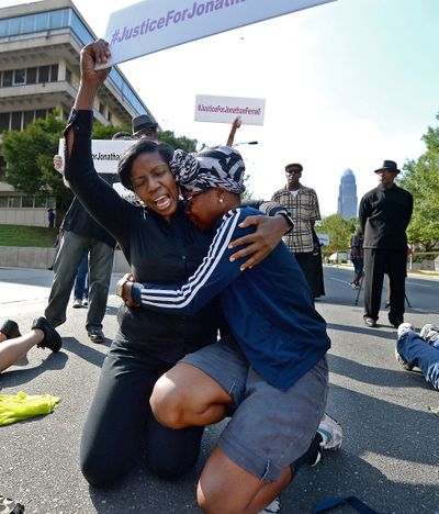 Kassandra Ottley, left, comforts Gloria Merriweather as she cries during a protest Friday on Fourth Street in Charlotte, N.C. (Associated Press)
