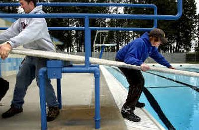 
Chris Rainville, left, and Seth Sather install a diving board at Terrace View pool Friday afternoon. Rainville and Sather will be managers and lifeguards at Valley Mission pool. 
 (Holly Pickett / The Spokesman-Review)