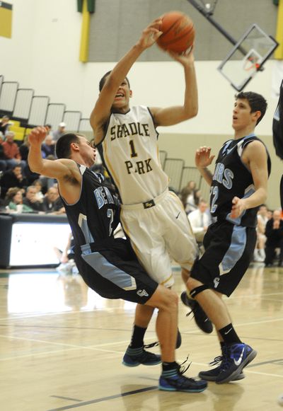 CV’s Dustin Dach, left, fouls Shadle Park’s Kionte Brown as he goes to the basket. (Christopher Anderson)