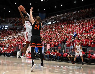 Washington State guard Noah Williams shoots over Oregon State forward Kylor Kelley during a Pac-12 Conference game Jan. 18 in Pullman.  (Colin Mulvany / The Spokesman-Review)