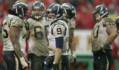 
Quarterback Drew Brees, center, and the San Diego Chargers were eliminated from playoff contention for the ninth time in 10 years Saturday. 
 (Associated Press / The Spokesman-Review)
