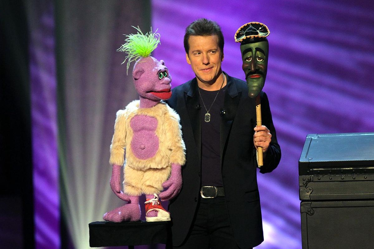 In this undated image released by Levity Productions, comedian Jeff Dunham performs with his ventriloquist dolls, Peanut, left, Jose Jalapeno during the taping of his comedy special “Controlled Chaos,” in Richmond, Virginia. (Tom Whitmore / AP)