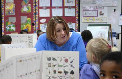 
Jacquie Blakley works with her morning kindergarten students during a writing exercise Tuesday at Grant Elementary School.   Blakley has a master''s degree in literacy. In 2005, 69 percent of Spokane County public K-12 teachers had a master''s degree. 
 (Dan Pelle / The Spokesman-Review)