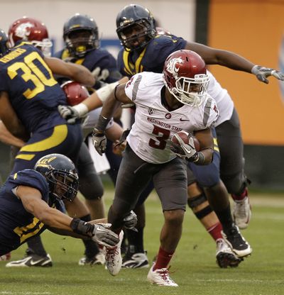 Washington State’s Carl Winston breaks a tackle against California in the second quarter Saturday. (Associated Press)