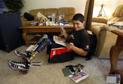Mohammad Malek takes a break from packing his bags at Loma Linda Medical Center in California  to look at photos from his stay in the United States. Los Angeles Times (Allen J. Schaben Los Angeles Times / The Spokesman-Review)
