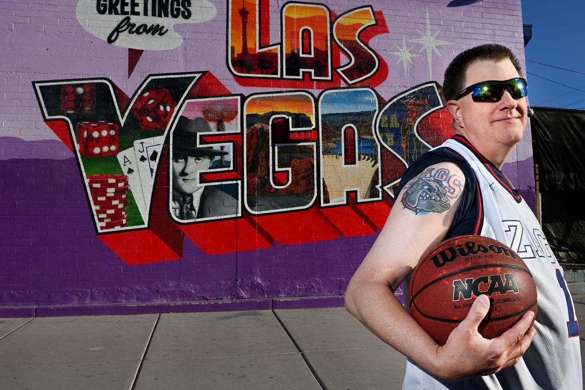 Gonzaga superfan Ed Dzama poses for a photo on Sunday in front of the Greetings From Las Vegas Mural in Las Vegas.  (Tyler Tjomsland/The Spokesman-Review)