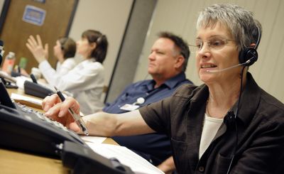 From right, Caroline Baker, Duff Little and Maryellen Cooley answer phone calls about the swine flu at the Spokane Regional Health District on Thursday. The number is (866) 800-4950.  (Dan Pelle / The Spokesman-Review)