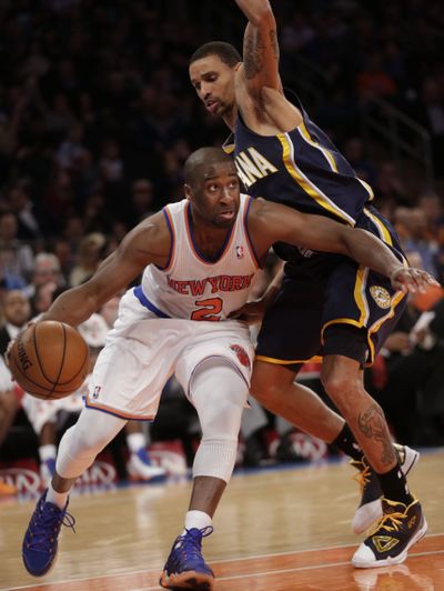 New York’s Raymond Felton, left, drives past Indiana’s George Hill as the Knicks earned a key win to lock up the East’s No. 2 spot. (Associated Press)
