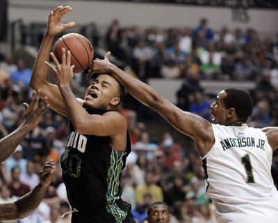 Ohio’s Reggie Keely if fouled by South Florida’s Ron Anderson Jr. in the second half of an NCAA tournament game Sunday in Nashville, Tenn. (Associated Press)