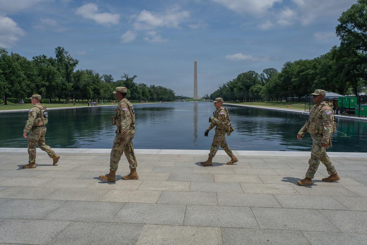 Mississippi National Guard members assigned to 890th Engineer Battalion, Joint Task Force Magnolia, patrol in front of the Lincoln Memorial Reflecting pool in Washington, D.C.  (Sgt. Christian Brown/U.S. Army National Guard )