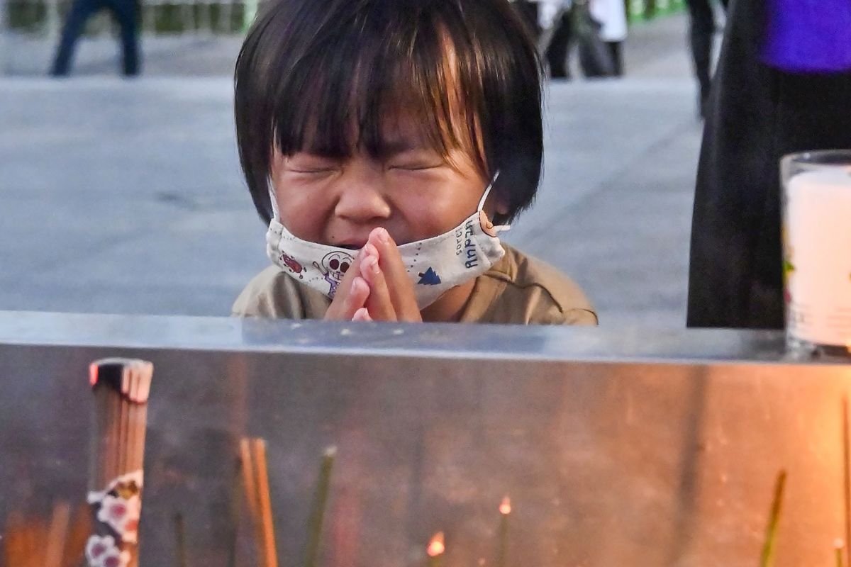 A child prays Friday in front of the cenotaph dedicated to atomic bombing victims at the Hiroshima Peace Memorial Park in Japan.  (SUB)