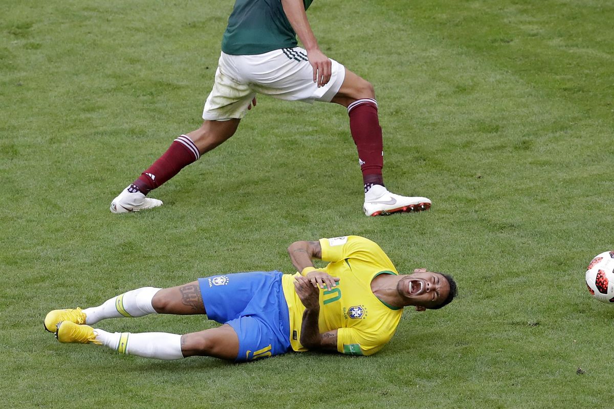 Brazil’s Neymar, bottom, challenges for the ball with Mexico’s Edson Alvarez during the round of 16 match between Brazil and Mexico at the World Cup in Samara, Russia, on Monday. (Sergei Grits / AP)