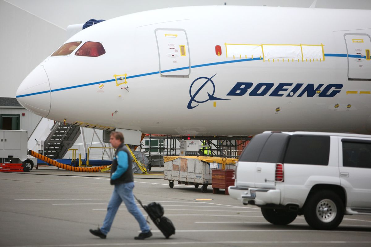 A worker walks past one of Boeing’s 787 Dreamliners at the production facility in Everett on Wednesday. (The Spokesman-Review)