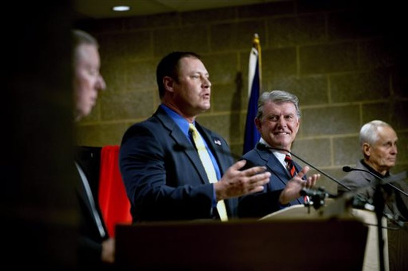 Idaho Gov. Butch Otter, second from right, listens to remarks made by Libertarian challenger, John Bujak, second from left, along with Democrat challenger A.J. Balukoff, left and Independent candidate Pro Life, right, during the governor's debate at Coeur d'Alene Library in Coeur d'Alene, Idaho on Friday, Oct. 3, 2014. Democratic governor candidate A.J. Balukoff came out swinging against incumbent GOP Gov. C.L. 