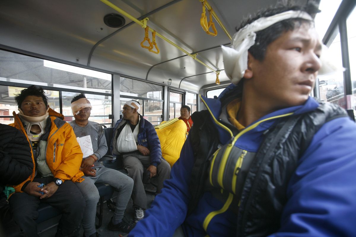 Injured Sherpa guides are evacuated from Mount Everest Base Camp, in Kathmandu, Nepal, Sunday. (Associated Press)